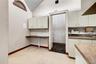 Kitchen featuring vaulted ceiling and baseboards