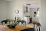 Kitchen featuring white shaker-style cabinetry, stainless steel range with a wall-mounted chimney hood, farmhouse-style sink, and flush-mount ceiling 