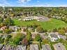 Aerial perspective featuring established residential density, mature canopy trees, and proximity to expansive green space