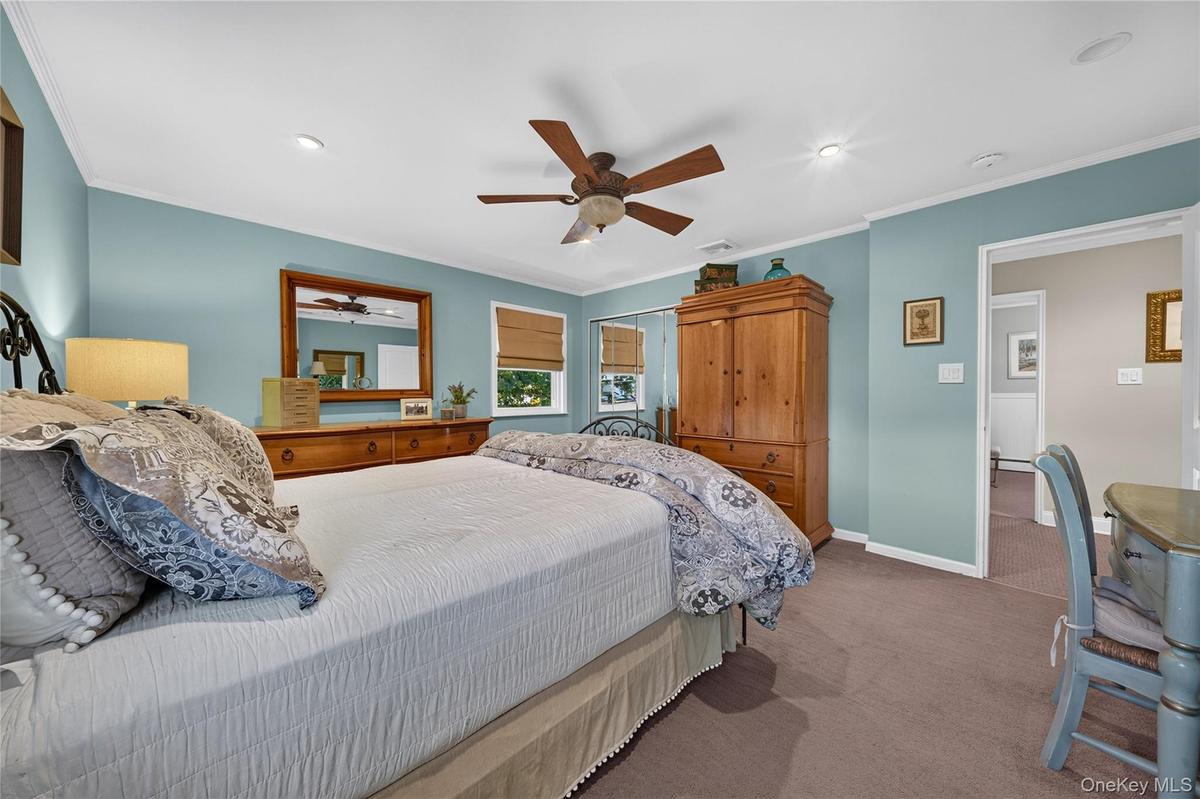 Bedroom featuring recessed lighting, a ceiling fan with integrated light fixture, carpeted flooring, and a mirrored closet
