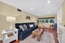 Wood-finish flooring, recessed lighting, and a multi-pane window featuring a window shade