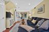Interior space featuring wood-finish flooring, recessed lighting, crown molding, and built-in cabinetry with integrated shelving