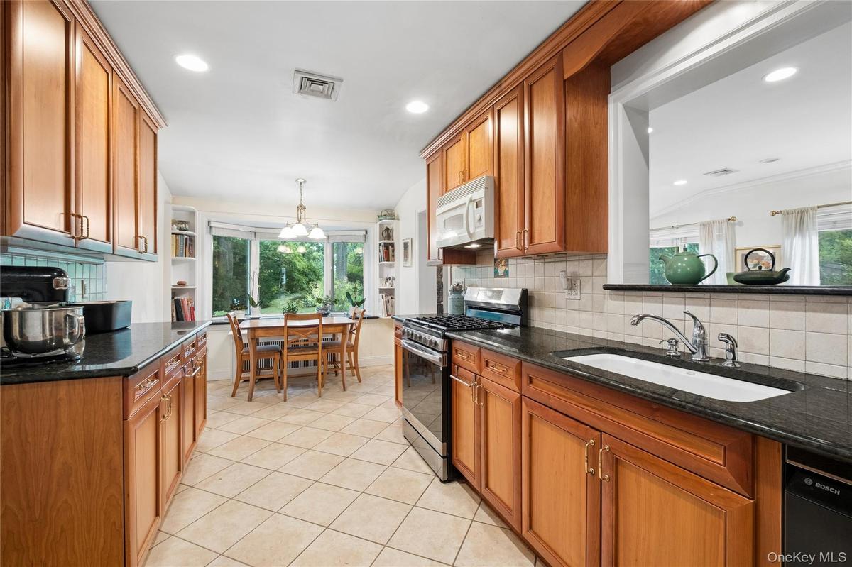 Renovated (2005) kitchen with view of backyard.  Wood Cabinets and granite countertops