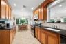 Renovated (2005) kitchen with view of backyard.  Wood Cabinets and granite countertops