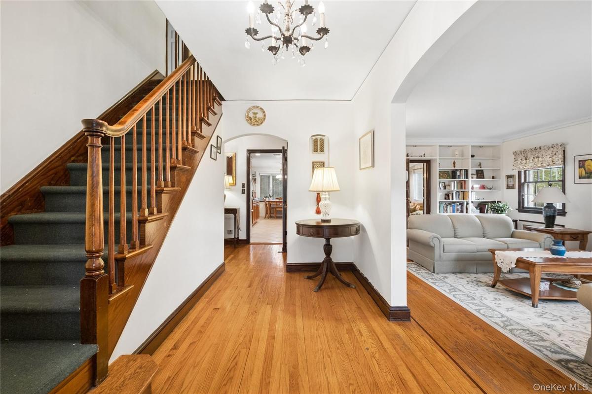 Large entry foyer w/ view of the stairs to 2nd floor and inviting living room