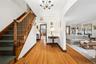 Large entry foyer w/ view of the stairs to 2nd floor and inviting living room