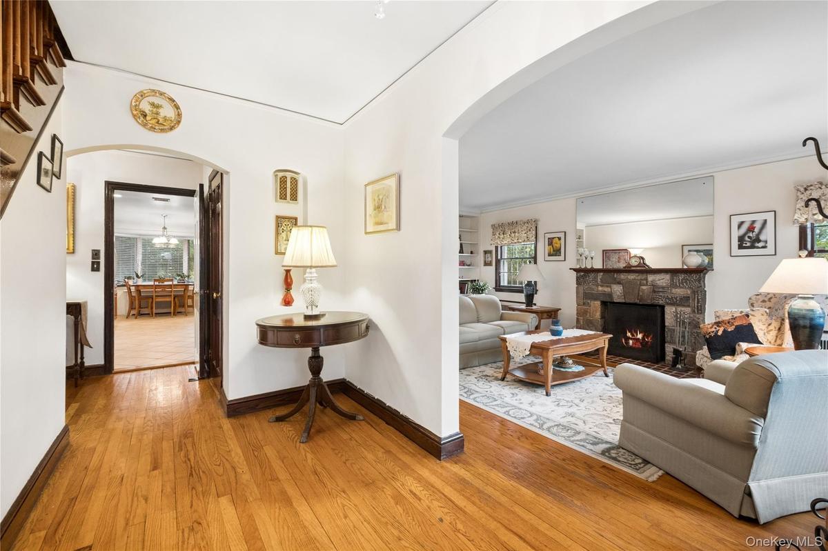 with view of living room and stone faced wood burning fireplace