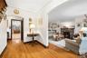 with view of living room and stone faced wood burning fireplace