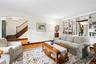 Living Room with built-in shelves and storage cabinets and view of entrance foyer