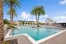 Relax and unwind at the stunning resort-style community pool surrounded by tropical landscaping.