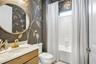 Beautifully styled bathroom featuring decorative wall finishes and elegant gold accents.