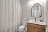 Bright bathroom featuring a contemporary vanity and stylish fixtures.