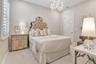 Another perspective highlighting the bedroom's elegant details and neutral finishes.