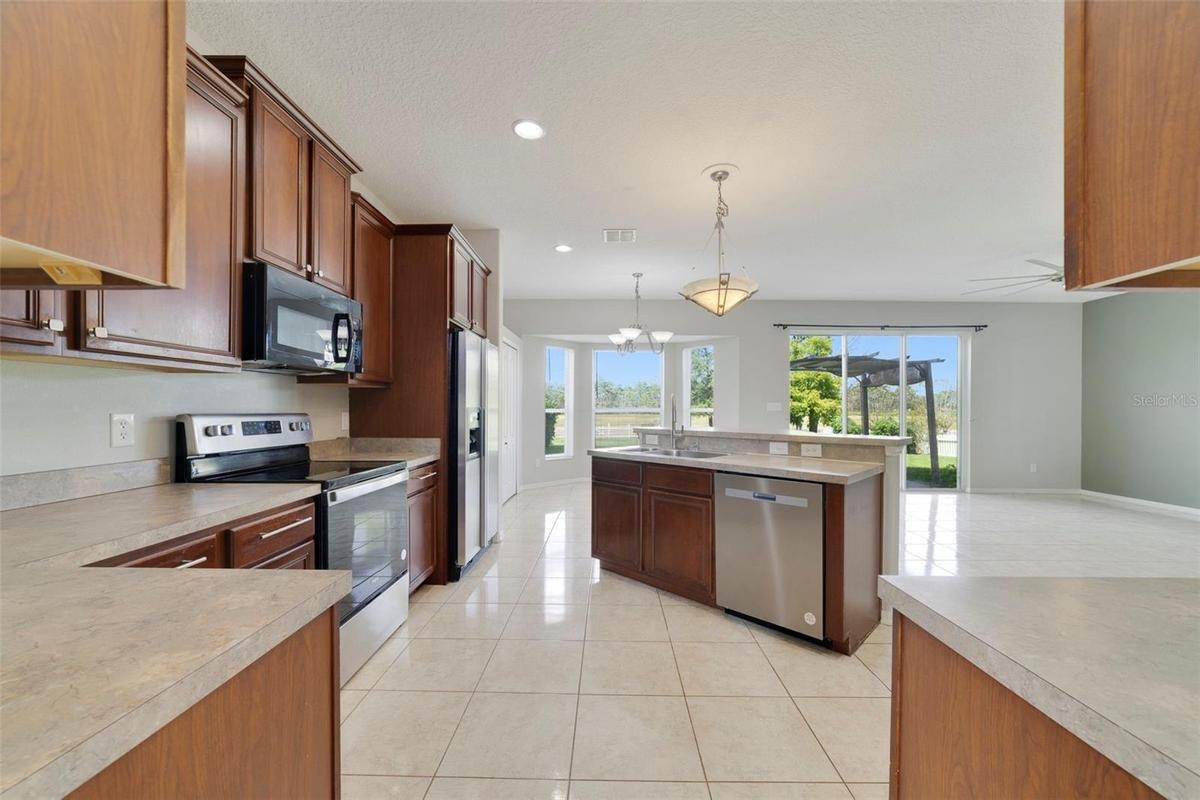 A center island with breakfast bar offers plenty of room for meal preparation and gathering.