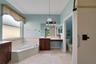 The Primary en suite Bath features dual vanities, a RELAXING GARDEN TUB, a step-in shower and a private water closet.