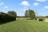 The spacious backyard is enclosed by a VINYL PICKET FENCE and backs to a CONSERVATION AREA providing a peaceful backdrop to enjoy the outdoors.