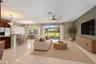 The Kitchen flows seamlessly into the Family Room, where triple sliding glass doors bring in NATURAL LIGHT and open to the back patio, extending the l