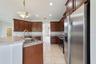 Step through an arched doorway into the spacious Kitchen with ABUNDANT STAGGERED CABINETRY and generous counter space.