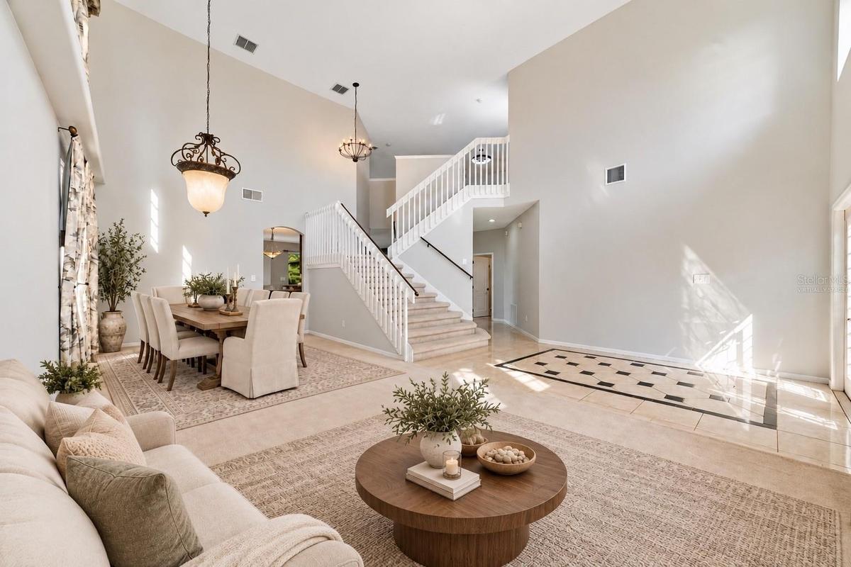 The formal LIVING ROOM/DINING ROOM COMBO share an elegant, open setting enhanced by 2-STORY CEILINGS where a chandelier and decorative ceiling medalli