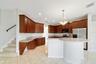 A center island with breakfast bar offers plenty of room for meal preparation and gathering.