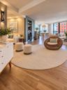 Wood-finish flooring throughout featuring a built-in recessed wet bar with integrated beverage refrigeration, expansive floor-to-ceiling windows, and 