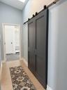 Walk-in closet is behind the barn door