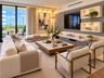 Living area featuring floor-to-ceiling sliding glass doors, built-in recessed shelving with integrated lighting, a custom wall-mounted media console, 