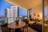 Covered balcony featuring tile flooring and a glass panel railing