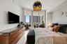 Floor-to-ceiling sliding glass doors, private balcony, polished tile flooring, and a decorative pendant light fixture