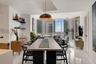 Open-concept space featuring floor-to-ceiling windows, polished tile flooring, recessed ceiling lighting, and matte black wall-mounted shelving