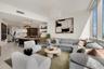 Open-concept floor plan featuring polished tile flooring, floor-to-ceiling windows, built-in shelving, and a tiered pendant light fixture