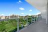 Covered balcony featuring concrete flooring and a glass-paneled railing