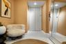 Private elevator access featuring smooth-finish metal doors, recessed ceiling lighting, and reflective wall-mounted mirror paneling