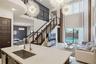 Double-height ceiling, open-plan interior featuring a floating staircase with cable railing, expansive floor-to-ceiling windows, dual sputnik-style ch
