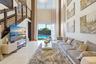 Double-height ceiling, polished tile flooring, staircase featuring dark wood-finish railings with horizontal cable balusters, and floor-to-ceiling gla