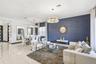 Polished tile flooring, textured navy blue accent wall, and two multi-tiered crystal chandeliers