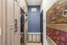 Custom floor-to-ceiling cabinetry with matte black hardware, integrated laundry appliances, and textured blue accent wall