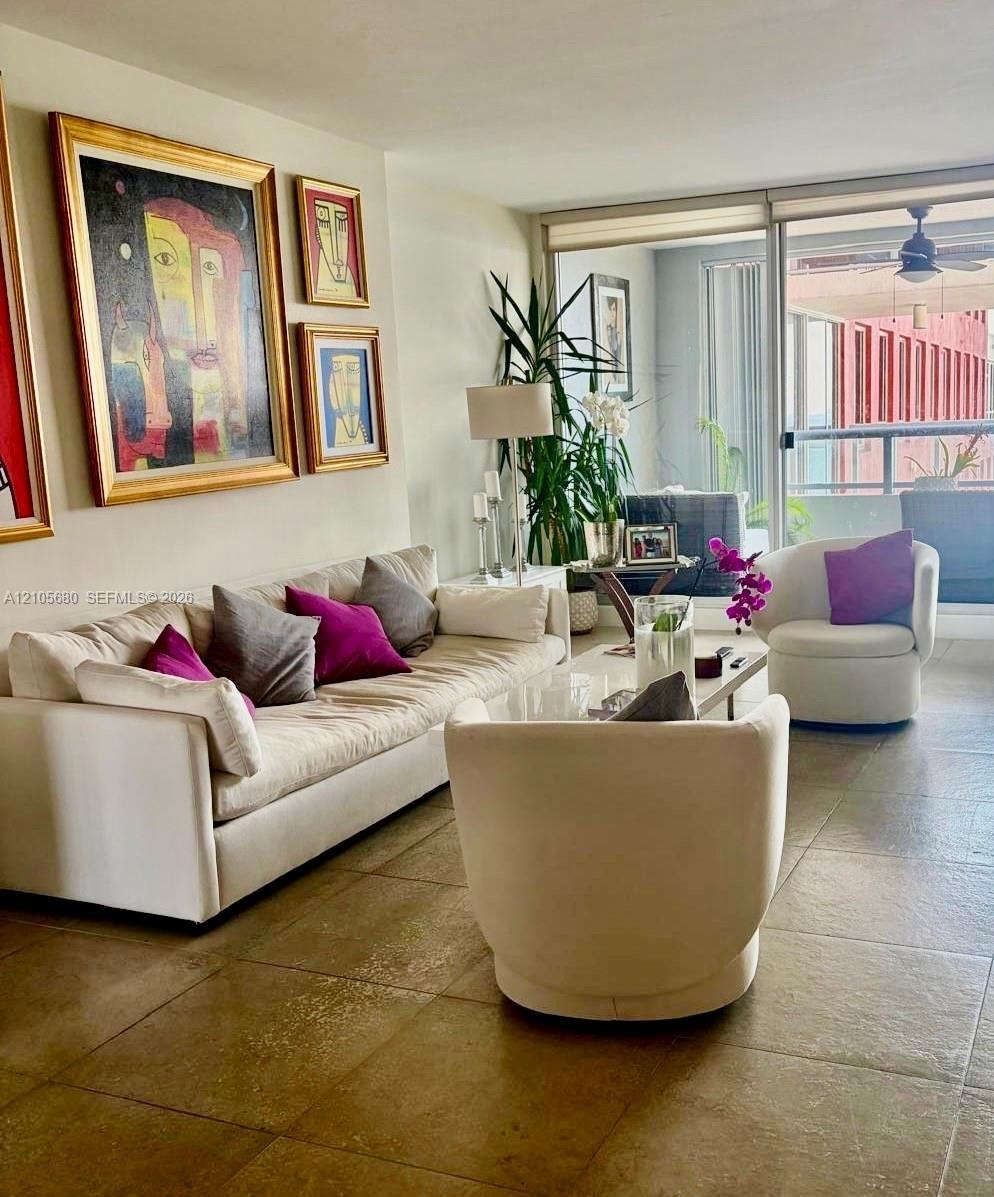 Large-format tile flooring, expansive sliding glass doors, and integrated balcony access