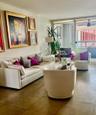 Large-format tile flooring, expansive sliding glass doors, and integrated balcony access