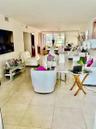 Large-format tile flooring, floor-to-ceiling glass sliding doors, and recessed ceiling lighting