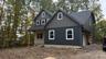 Construction Progress Photo of Exterior Siding Installation in Progress.