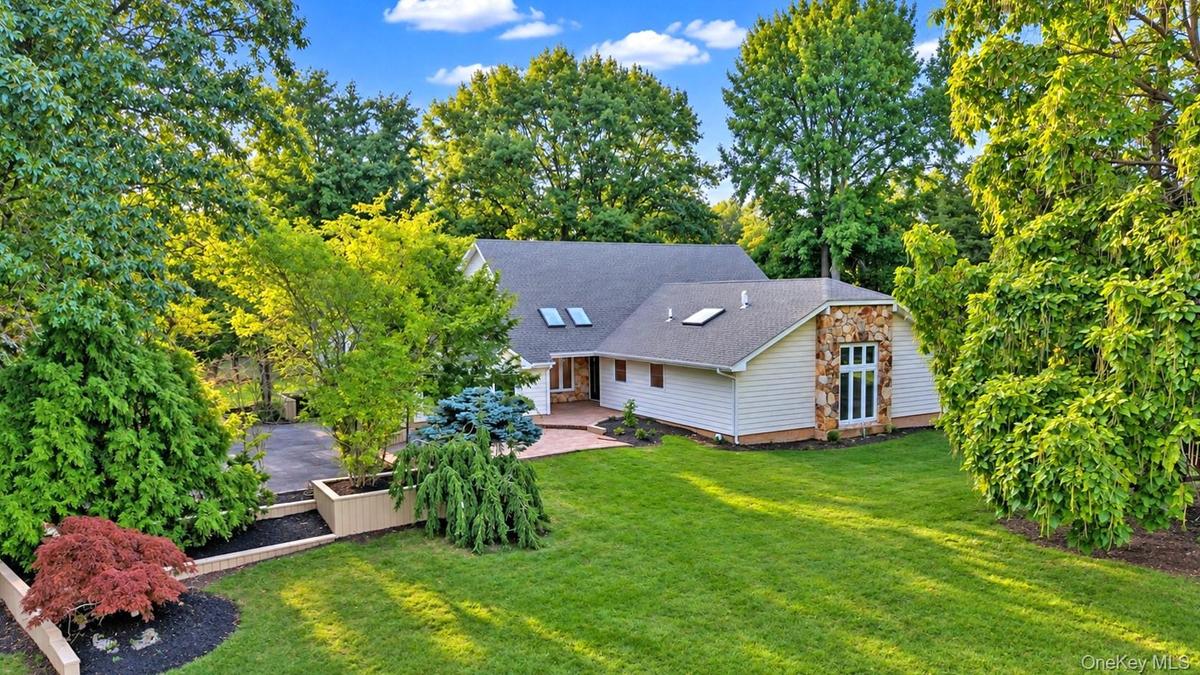 Expansive lawn with mature trees and diverse landscaping