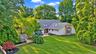 Expansive lawn with mature trees and diverse landscaping
