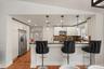 Kitchen with breakfast bar seating and pendant lighting