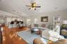 Living room with vaulted ceiling open to the dining area and kitchen