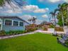 Backyard turf with rear exterior, pergola deck, and outdoor kitchen