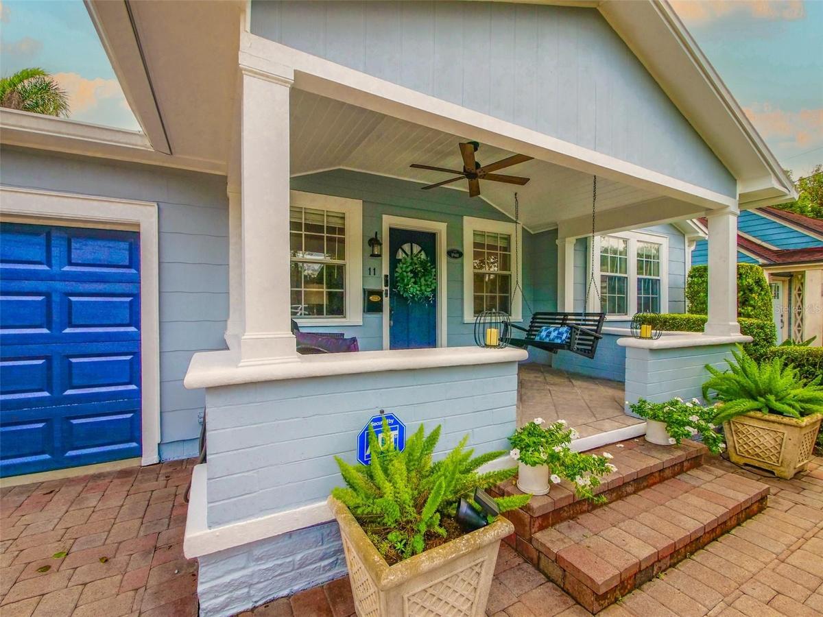 Covered front porch with ceiling fan and porch swing