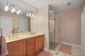 Primary bathroom with dual vanity and glass-enclosed shower