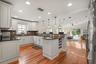 Kitchen open to the living room with sliding glass doors to the rear deck