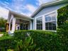 Covered front porch and front windows with landscaped hedges